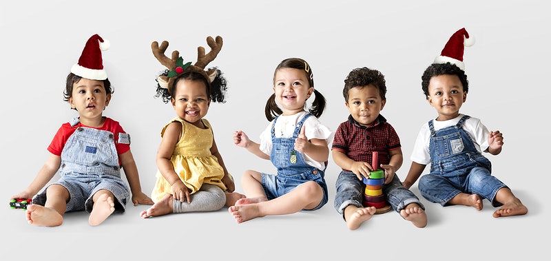 Cute diverse toddlers sitting together on the floor