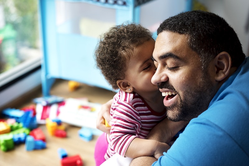 Little girl kissing dad on the cheek